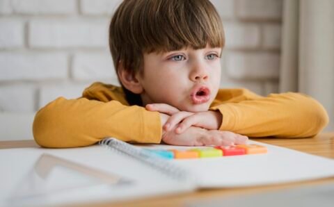 front-view-child-desk-learning-from-laptop
