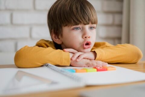 front-view-child-desk-learning-from-laptop