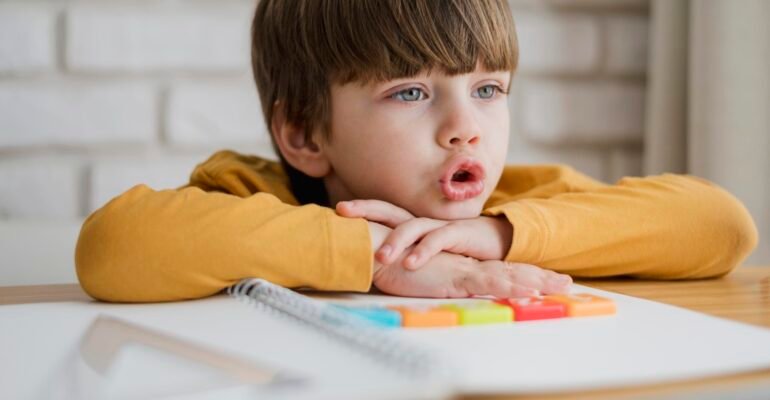 front-view-child-desk-learning-from-laptop